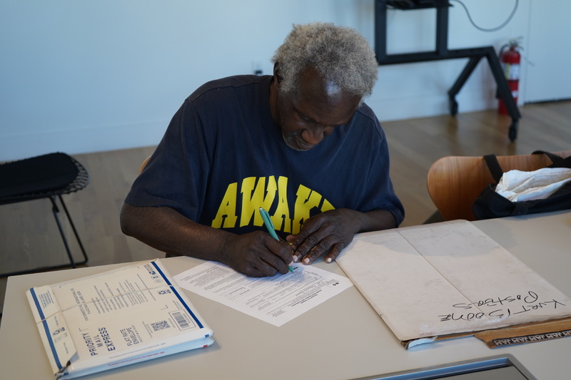 Kurt Boone Signing the Acquisition Agreement for the Cave Canem Archives