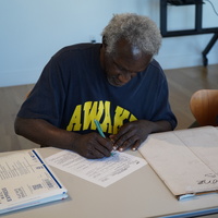 Kurt Boone Signing the Acquisition Agreement for the Cave Canem Archives